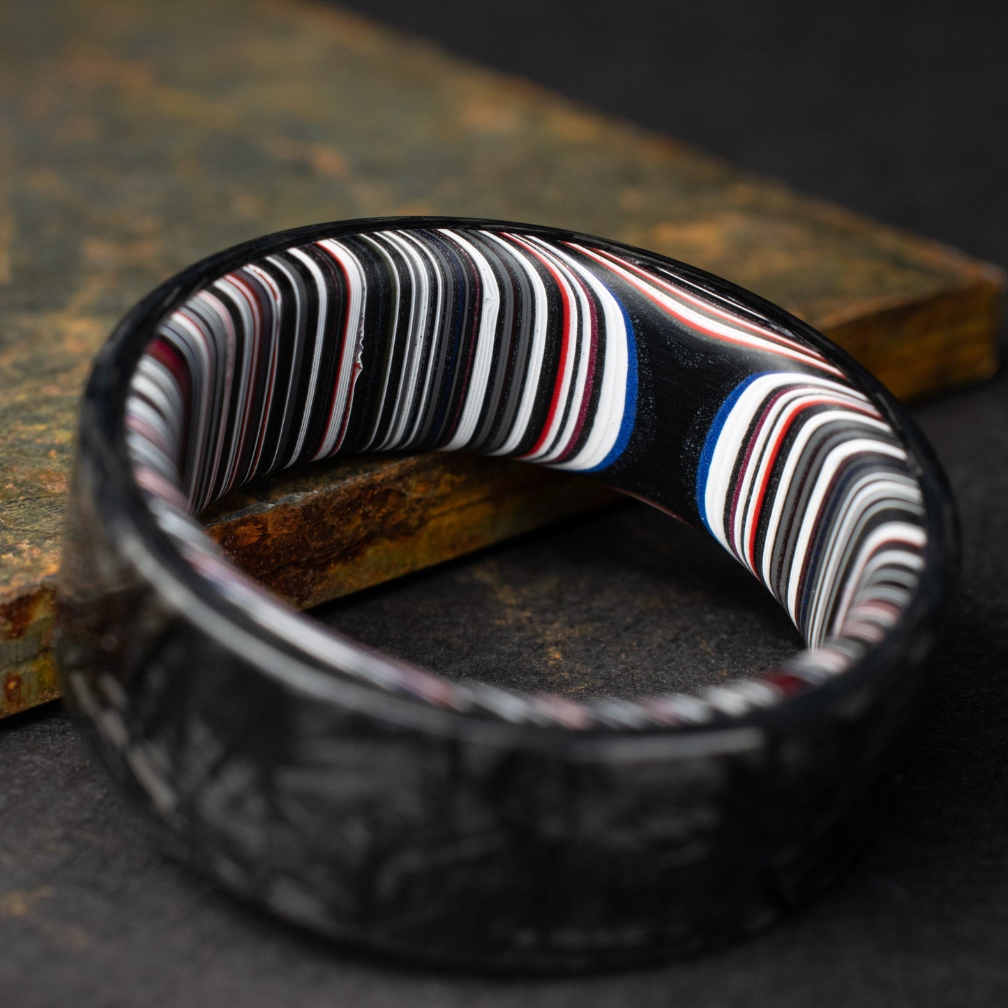 Chopped Carbon Fiber Ring Lined With Crosscut Fordite. Polished Carbon Fiber
