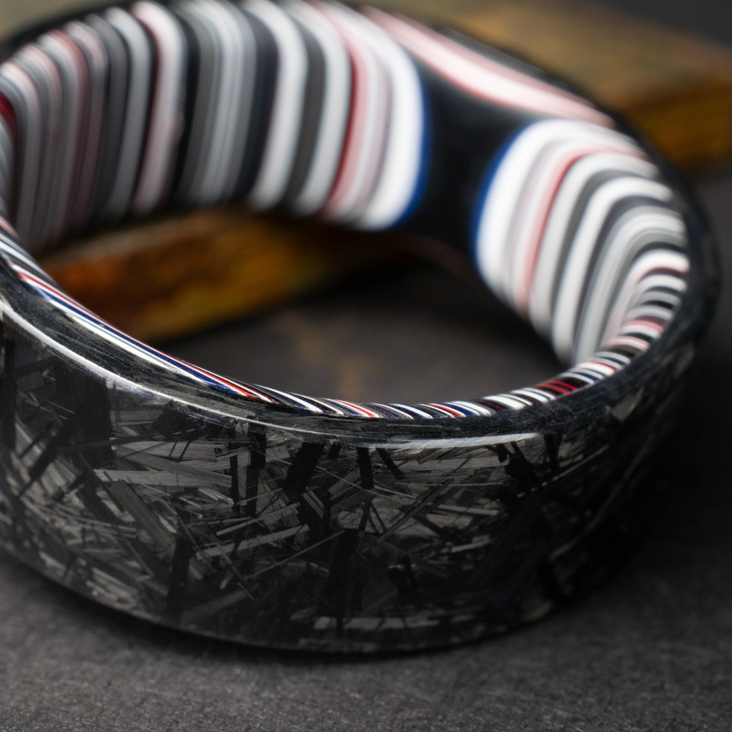 Chopped Carbon Fiber Ring Lined With Crosscut Fordite. Polished Carbon Fiber