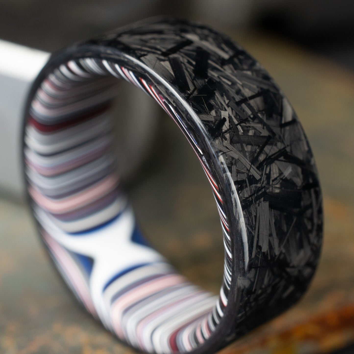 Chopped Carbon Fiber Ring Lined With Crosscut Fordite. Polished Carbon Fiber