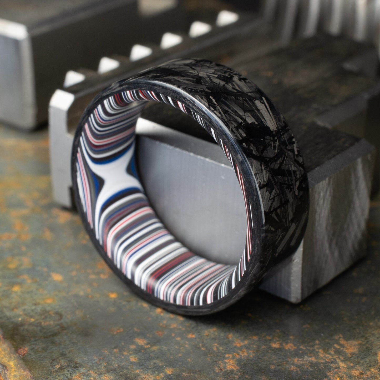Chopped Carbon Fiber Ring Lined With Crosscut Fordite. Polished Carbon Fiber