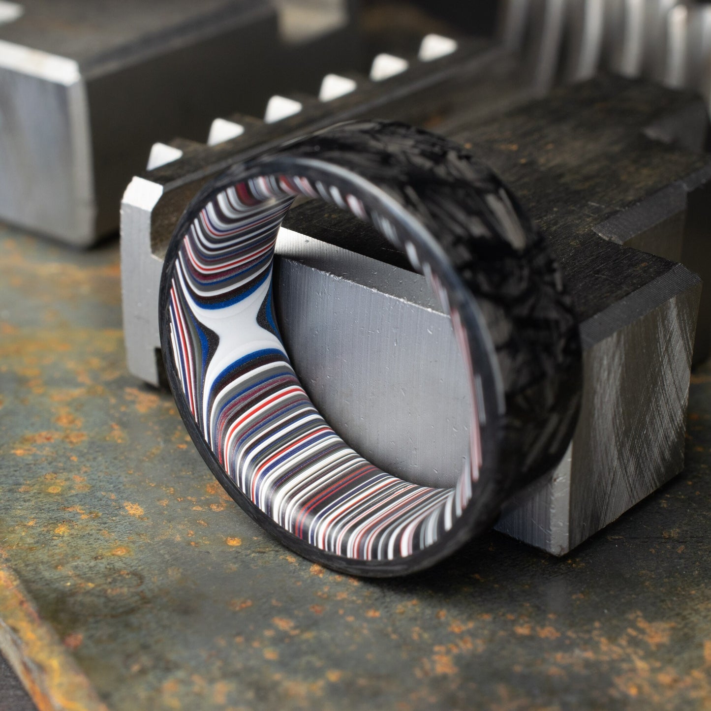 Chopped Carbon Fiber Ring Lined With Crosscut Fordite. Polished Carbon Fiber
