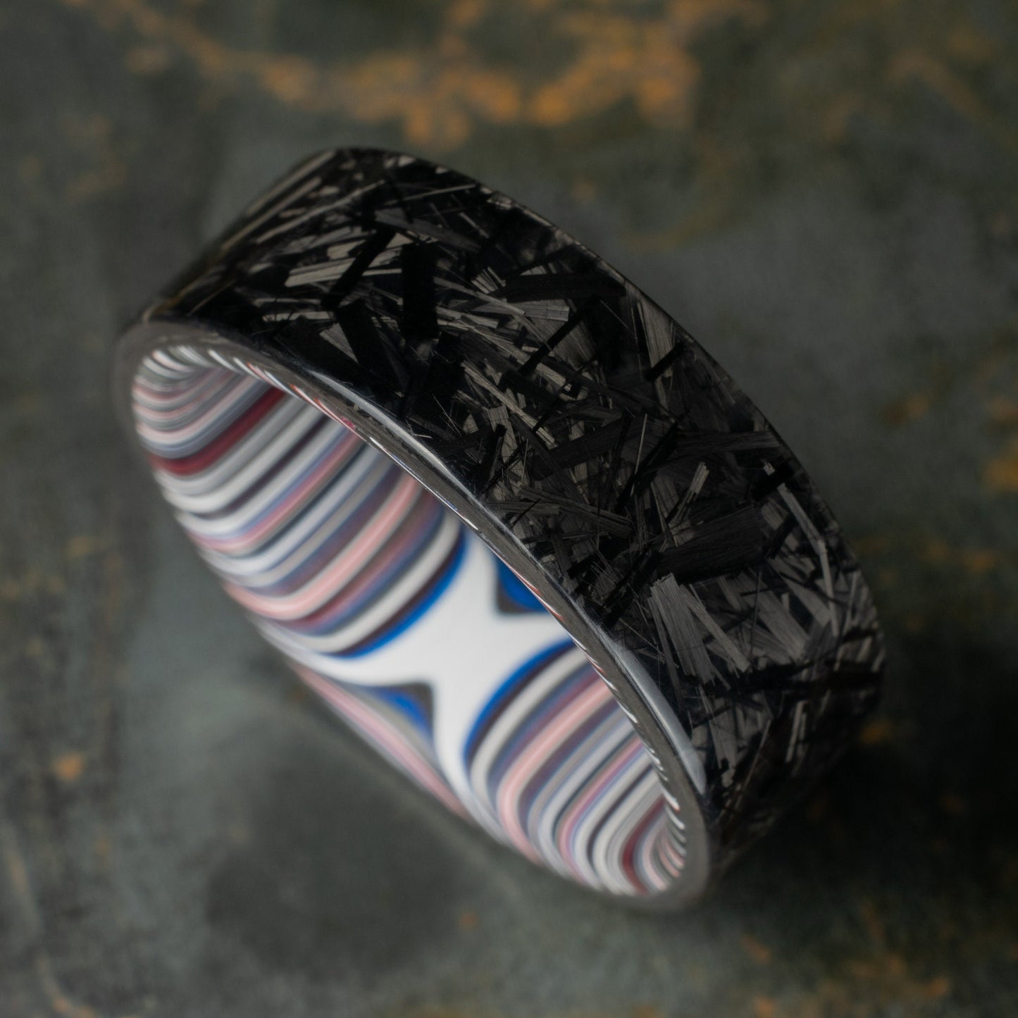 Chopped Carbon Fiber Ring Lined With Crosscut Fordite. Polished Carbon Fiber