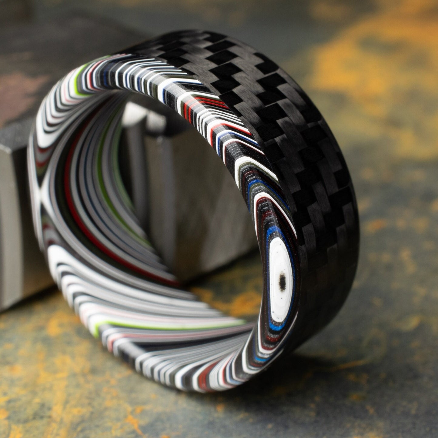 1k Twill Carbon Fiber Ring Lined With Tilted Premium Fordite In a Flipped Cuff Design