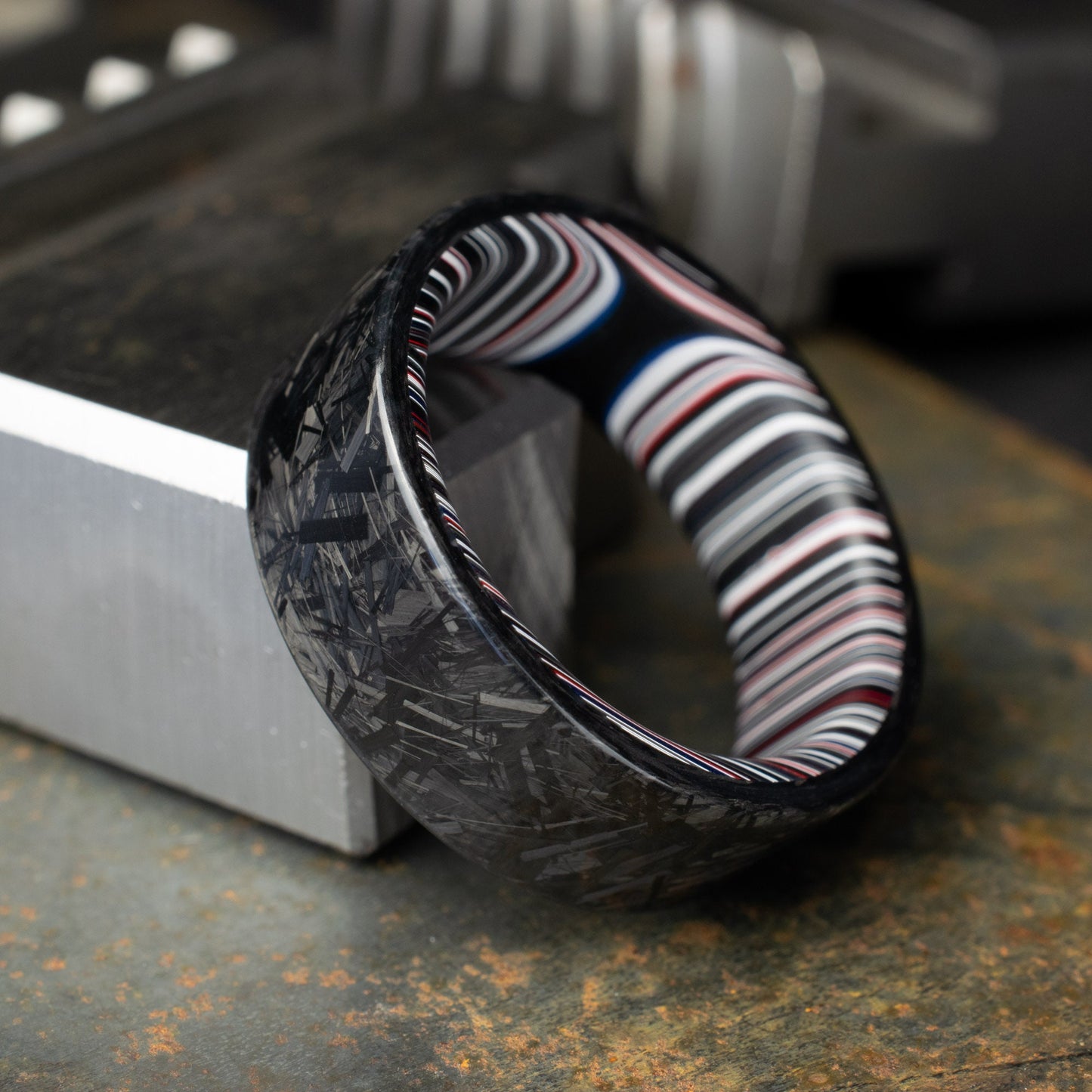 Chopped Carbon Fiber Ring Lined With Crosscut Fordite. Polished Carbon Fiber