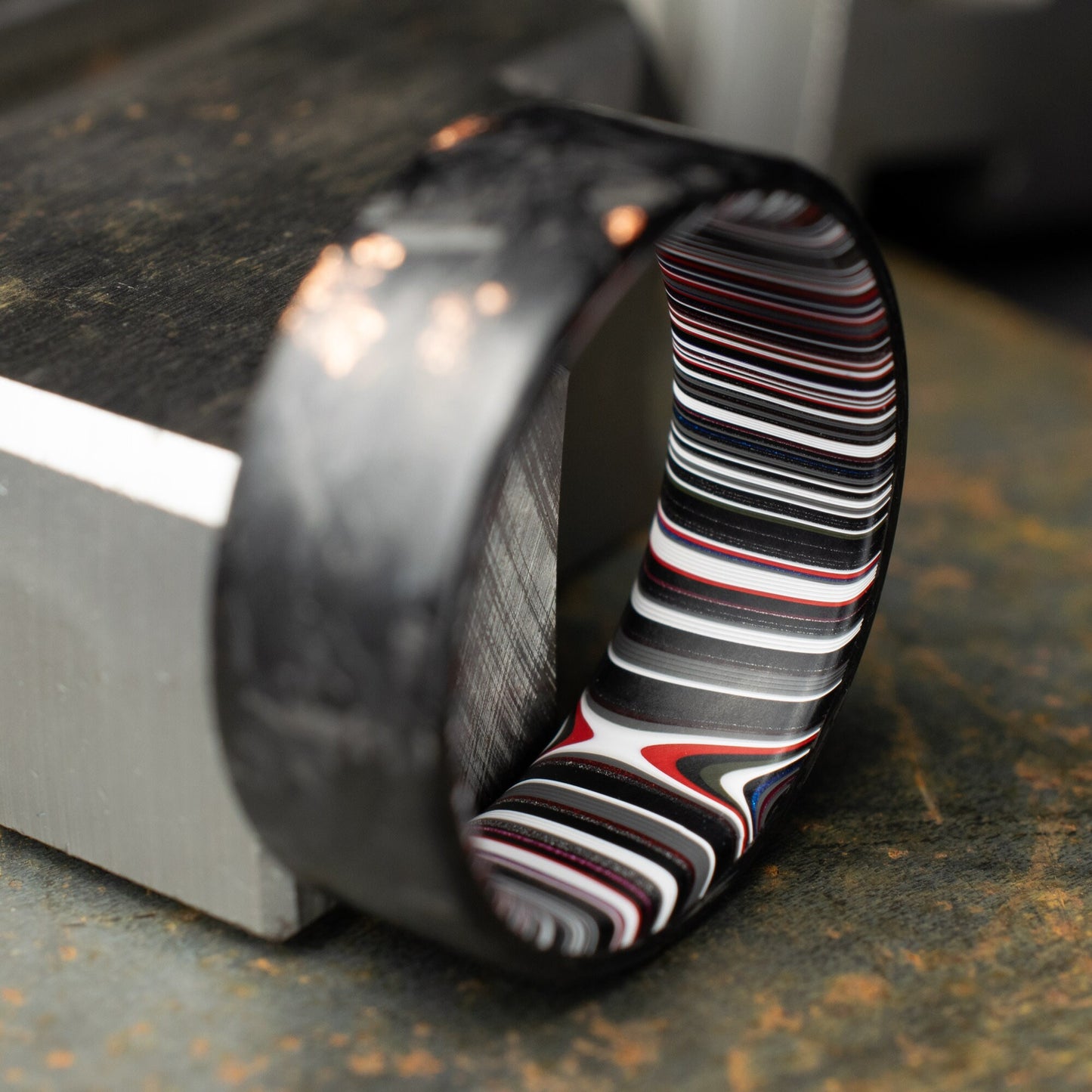 Men's Wedding Band, Copper Chopped Carbon Fiber, Lined With Crosscut Fordite. Matte Finish Carbon Fiber.