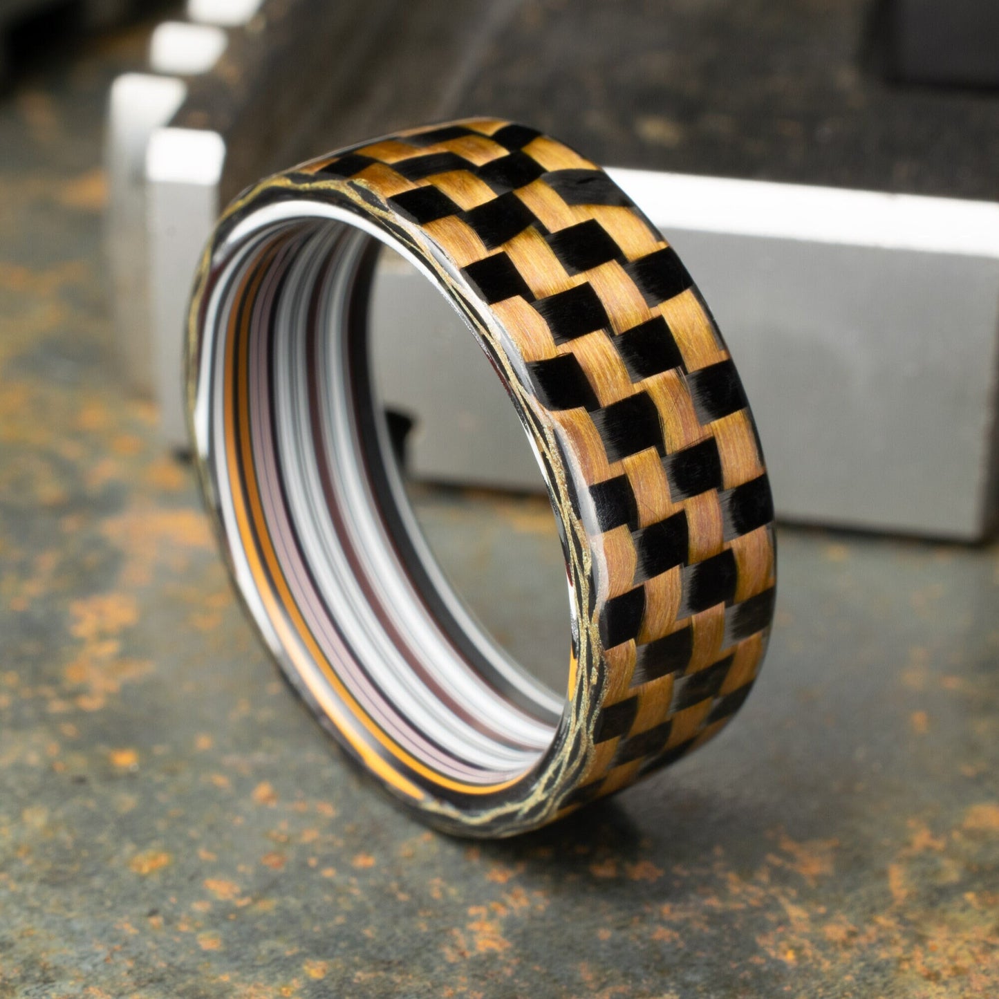 Checkered Zylon/Carbon Fiber Ring Lined With Straight Cut Fordite. Gloss Finish Zylon/Carbon Fiber. Men's Wedding Band.