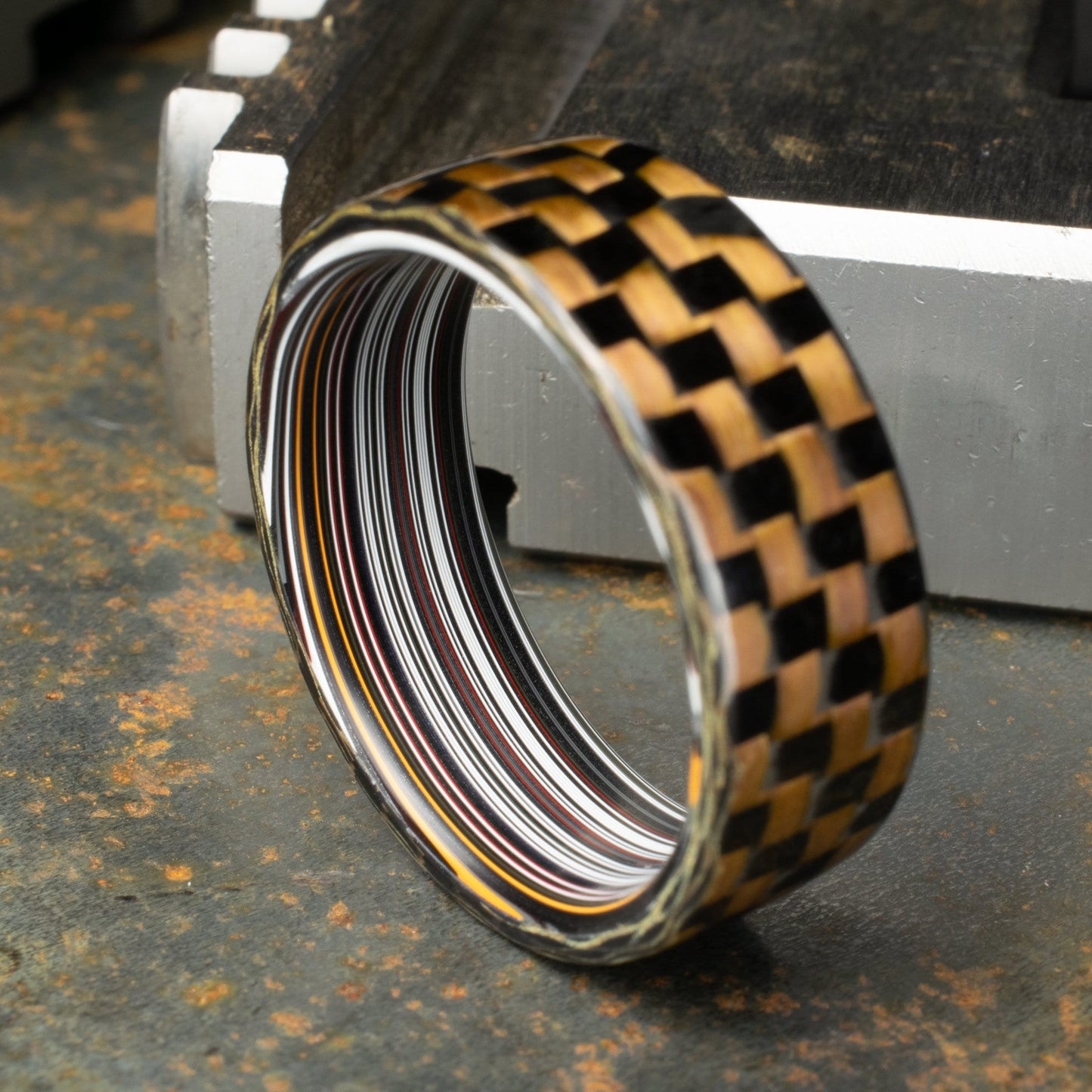 Checkered Zylon/Carbon Fiber Ring Lined With Straight Cut Fordite. Gloss Finish Zylon/Carbon Fiber. Men's Wedding Band.