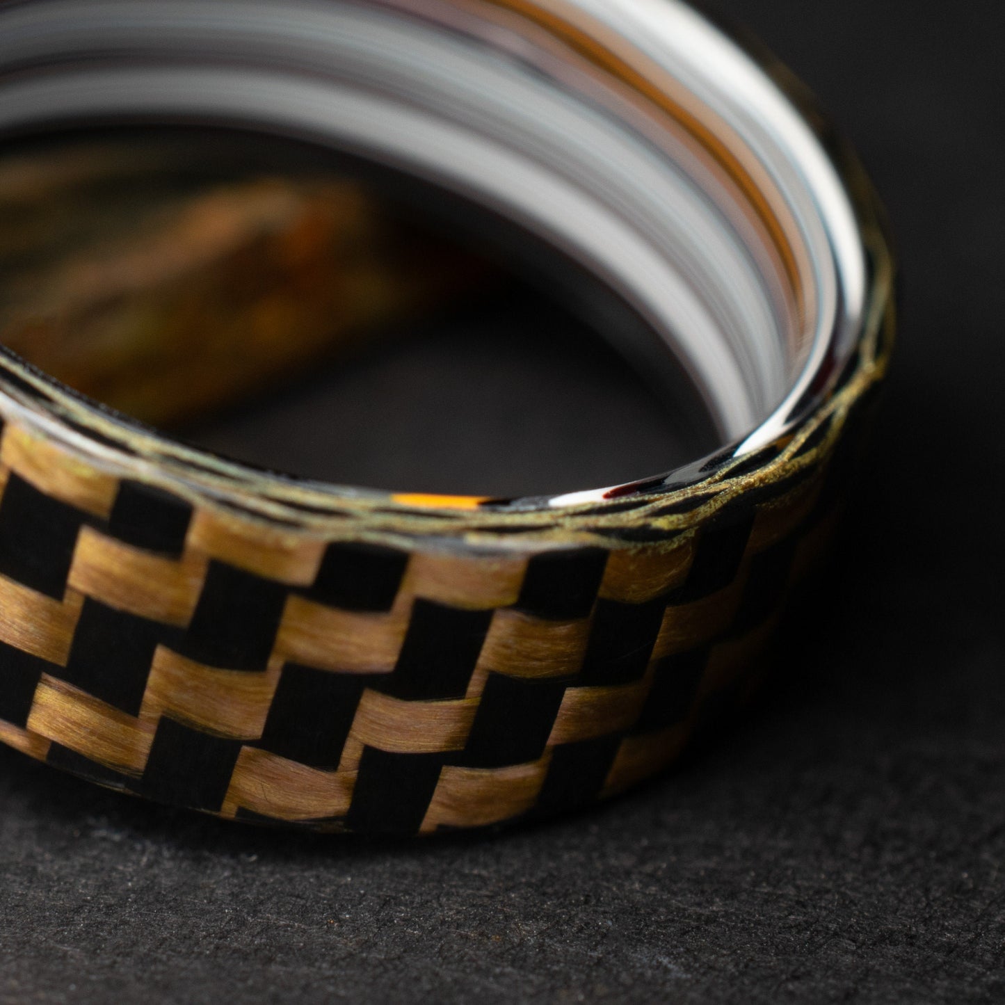 Checkered Zylon/Carbon Fiber Ring Lined With Straight Cut Fordite. Gloss Finish Zylon/Carbon Fiber. Men's Wedding Band.