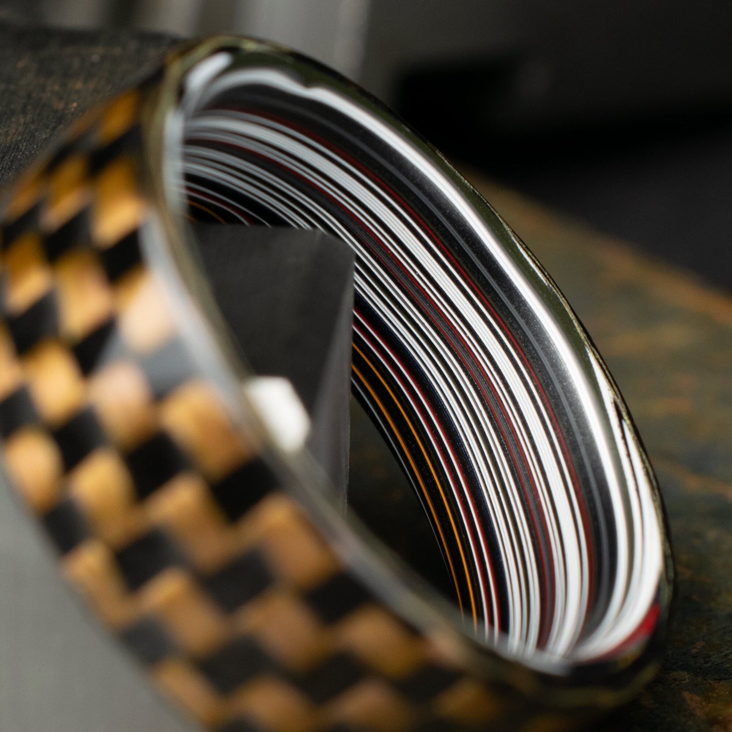 Checkered Zylon/Carbon Fiber Ring Lined With Straight Cut Fordite. Gloss Finish Zylon/Carbon Fiber. Men's Wedding Band.