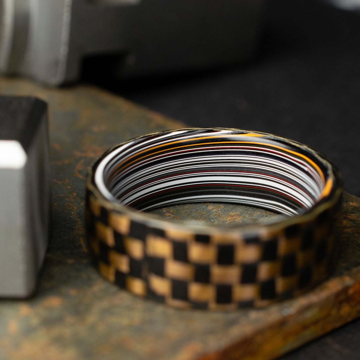 Checkered Zylon/Carbon Fiber Ring Lined With Straight Cut Fordite. Gloss Finish Zylon/Carbon Fiber. Men's Wedding Band.