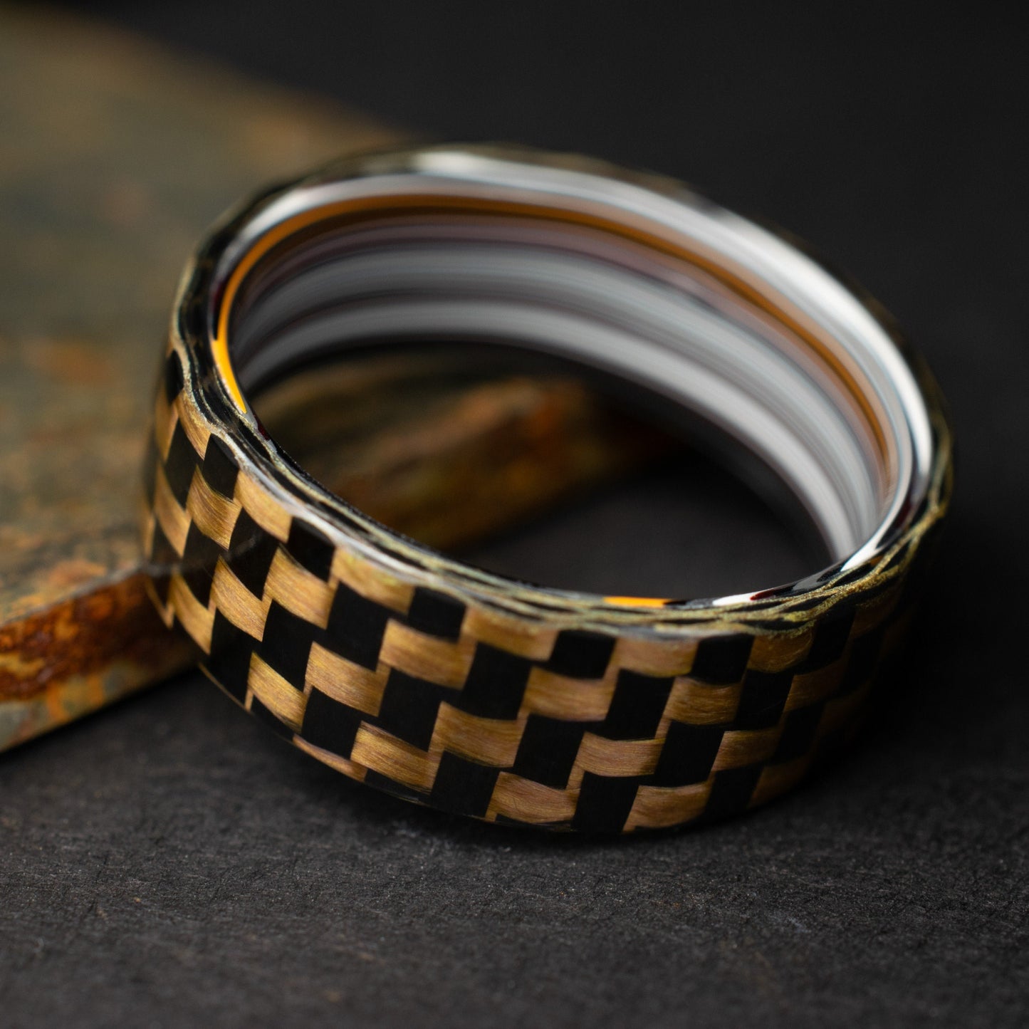 Checkered Zylon/Carbon Fiber Ring Lined With Straight Cut Fordite. Gloss Finish Zylon/Carbon Fiber. Men's Wedding Band.